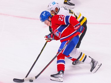 Canadiens' Cole Caufield controls the puck while being checked by Pittsburgh Penguins' Pierre-Olivier Joseph during the first period at the Bell Centre in Montreal Monday Oct. 17, 2022.