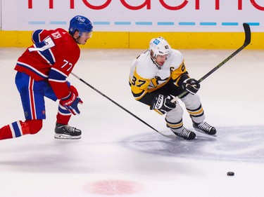 Canadiens' Kirby Dach chases down Pittsburgh Penguins' Sidney Crosby during the first period at the Bell Centre in Montreal Monday Oct. 17, 2022.