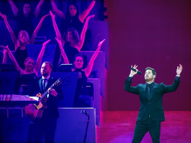 Members of the string section perform choreographed movements during Michael Bublé's show at the Bell Centre in Montreal Tuesday Oct. 18, 2022.