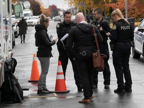 Laval police officers and detectives at the scene of double murder on Tuesday October 18, 2022.