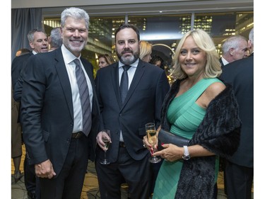 Paul-Eric Poitras, left, Patrick Mayne and Maryse Cheney at a fundraiser cocktail for La Fondation immobilière de Montréal pour les jeunes at the Queen Elizabeth Hotel in Montreal on Friday, Oct. 21, 2022.
