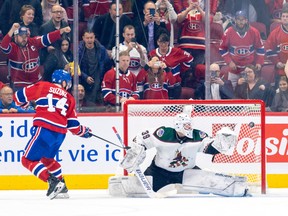 Canadiens' Nick Suzuki shot the puck past Connor Ingram of the Arizona Coyotes on a penalty shot in the second period of the National Hockey League game in Montreal on Thursday, Oct. 20, 2022.