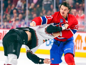 Arber Xhekaj of the Canadiens hits Arizona Coyotes Zack Kassian during the first period of a National Hockey League game in Montreal on Thursday, Oct. 20, 2022.