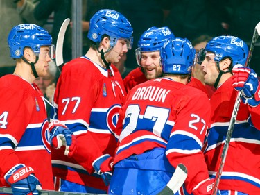 Canadiens, from left, Jordan Harris, Kirby Dach, Jonathan Drouin and Chris Wideman, right, celebrate with Josh Anderson after his first-period goal in a National Hockey League game in Montreal Thursday Oct. 20, 2022.