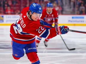 The Canadiens' Cole Caufield completes a shot during a game against the Arizona Coyotes in Montreal on Thursday, Oct. 20, 2022.