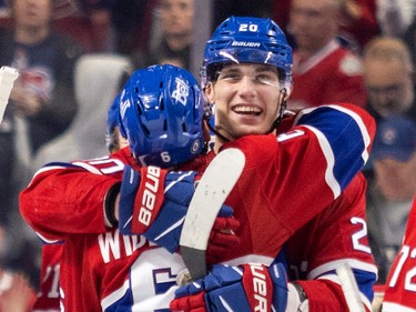 Canadiens' Juraj Slafkovsky gets a hug from teammate Chris Wideman following the team's victory over the Arizona Coyotes in a National Hockey League game in Montreal Thursday Oct. 20, 2022.
