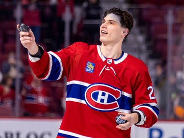 Canadiens' Juraj Slafkovsky tosses a puck into the stands after being named the first star of the Habs' victory over the Arizona Coyotes at the Bell Centre in Montreal Thursday Oct. 20, 2022.  Slafkovsky scored his first career goal in the game.  (John Mahoney / MONTREAL GAZETTE)/