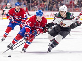 Canadiens' Cole Caufield controls the puck against Arizona Coyotes' Shayne Gostisbehere during the third period of a National Hockey League game in Montreal Thursday Oct. 20, 2022. Habs' Sean Monahan trails the play.