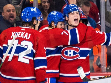 Canadiens' Juraj Slafkovsky, right, celebrates with teammates Arber Xhekaj and Jake Evans after scoring his first career goal against the Arizona Coyotes during the second period of a National Hockey League game in Montreal Thursday Oct. 20, 2022.