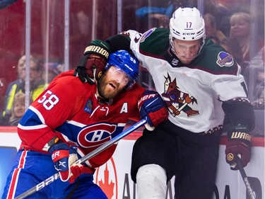 Canadiens' David Savard gets grabbed around the neck by Arizona Coyotes' Nick Bjugstad during the second period of a National Hockey League game in Montreal Thursday Oct. 20, 2022.