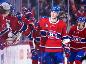 Canadiens' Juraj Slafkovsky gets high fives from team-mates after scoring his first career goal against the Arizona Coyotes during second period of National Hockey League game in Montreal Thursday Oct. 20, 2022.