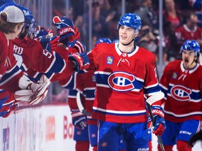 Canadiens' July Slafkowski scores his first career goal against the Arizona Coyotes in the second period of a National Hockey League game in Montreal on Thursday, October 20, 2022, and receives a high-five from his teammates. .