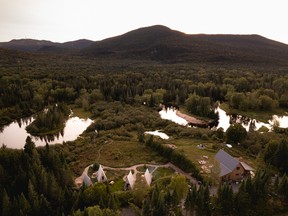 Farouche is a glamping domain with A-frame cabins (shown in the foreground) in Lac-Supérieur.