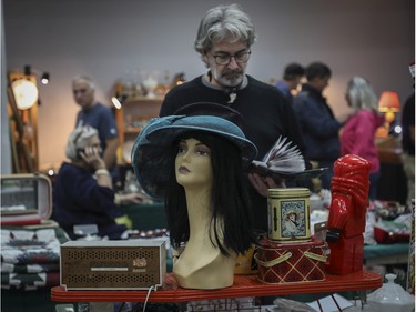Marco (no last name given) looks at items at a vintage bazaar at Saint-Jean-Berchmans Church in Montreal on Sunday, Oct. 23, 2022.