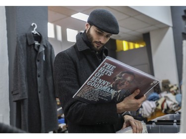 Yohan Cormier checks out liner notes on a Benny Goodman LP at a vintage bazaar at Saint-Jean-Berchmans Church in Montreal on Sunday, Oct. 23, 2022.