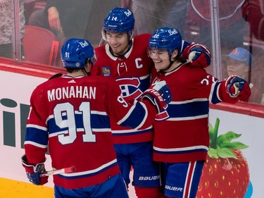 Montreal Canadiens right wing Cole Caufield (22) is congratulated by teammates Montreal Canadiens centre Sean Monahan (91) and centre Nick Suzuki (14) after scoring against Minnesota Wild during 2nd period NHL action at the Bell Centre in Montreal on Tuesday Oct. 25, 2022.