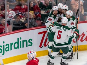 Minnesota Wild right wing Brandon Duhaime (21) is congratulated by teammates after scoring against Montreal Canadiens goaltender Jake Allen (34) during 2nd period NHL action at the Bell Centre in Montreal on Tuesday Oct. 25, 2022.