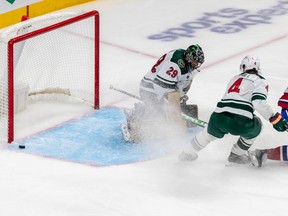 Montreal Canadiens left wing Mike Hoffman (68) came close to scoring against Minnesota Wild goaltender Marc-André Fleury (29) but was awarded a penalty shot on the play after being tied up by Minnesota Wild defenceman Jon Merrill (4) during 3rd period NHL action at the Bell Centre in Montreal on Tuesday Oct. 25, 2022.