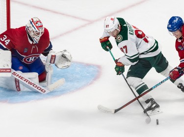 The back checking of Montreal Canadiens right wing Cole Caufield (22) prevented Minnesota Wild left wing Kirill Kaprizov (97) from getting a clean shot off against Montreal Canadiens goaltender Jake Allen (34) during 2nd period NHL action at the Bell Centre in Montreal on Tuesday Oct. 25, 2022.
