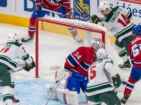 Minnesota Wild right wing Brandon Duhaime (21) and Minnesota Wild defenceman Jacob Middleton (5) watch as the shot from Minnesota Wild center Joel Eriksson Ek (14) crosses the goal line against Montreal Canadiens goaltender Jake Allen (34) during 1st period NHL action at the Bell Centre in Montreal on Tuesday October 25, 2022. Dave Sidaway / Montreal Gazette