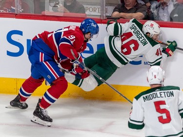 Minnesota Wild defenceman Jared Spurgeon (46) is checked into the boards by Montreal Canadiens centre Sean Monahan (91) during 3rd period NHL action at the Bell Centre in Montreal on Tuesday Oct. 25, 2022.