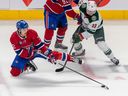Montreal Canadiens defenceman Arber Xhekaj tries to corral the puck against Minnesota Wild centre Sam Steel during third period at the Bell Centre in Montreal on Oct. 25, 2022.