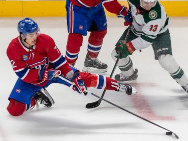 Montreal Canadiens defenseman Arber Xhekaj (72) tries to corral the puck against Minnesota Wild center Sam Steel (13) during 3rd period NHL action at the Bell Centre in Montreal on Tuesday Oct. 25, 2022.
