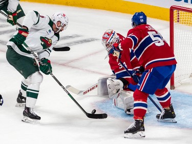 Montreal Canadiens defenceman David Savard (58) watches as Minnesota Wild defenceman Jacob Middleton (5) is stopped at the goalmouth by Montreal Canadiens goaltender Jake Allen (34) during 1st period NHL action at the Bell Centre in Montreal on Tuesday Oct. 25, 2022.