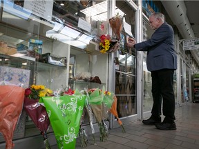 NHL.com columnist Dave Stubbs puts up a hockey card of Boston Bruins player Fred Stanfield, which he had purchased for a story at Bluenose Collectibles, as a tribute to store manager Wayne Arnott who was murdered at his home last week. (Pierre Obendrauf / MONTREAL GAZETTE)