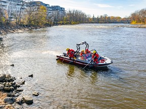 Laval firefighters search for a missing child near the shore of the Rivière des Mille Îles in Laval on Oct. 29, 2022.