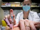 Nurse Jessica Mann Bourgouin administers a flu shot in 2020.