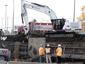 Construction crews work on a retaining wall as part of the La Fontaine tunnel project on Oct. 31, 2022.