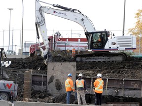 Construction crews work on a retaining wall as part of the La Fontaine Tunnel project, in Montreal Oct. 31, 2022.