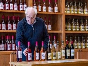 Philippe Druelle arranges wine bottles in the retail space at his Souffle de Vie winery in Senneville.