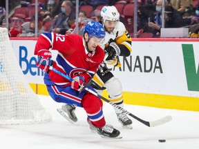 Montreal Canadiens winger Jonathan Drouin protects the puck from Pittsburgh Penguins' Kris Letang during third period in Montreal on Nov. 18, 2021.