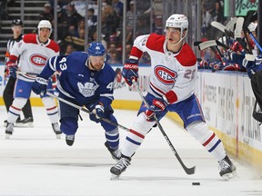 Montreal Canadiens' Juraj Slafkovsky handles the puck against Kyle Clifford of the Toronto Maple Leafs during an preseason game at Scotiabank Arena on Sept. 28, 2022, in Toronto.