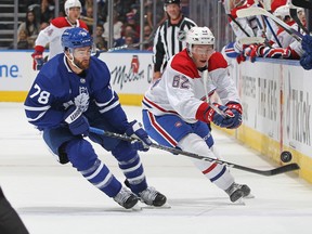 Owen Beck of the Montreal Canadiens flips the puck away against T.J. Brodie of the Toronto Maple Leafs at Scotiabank Arena on Sept. 28, 2022, in Toronto.