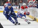 Owen Beck of the Montreal Canadiens throws the puck against TJ Brodie of the Toronto Maple Leafs at Scotiabank Arena on September 28, 2022 in Toronto.