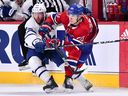 Leafs and Canadiens' Juraj Slafkovsky, right, battles with Leafs defenceman Morgan Rielly Monday night at the Bell Centre.