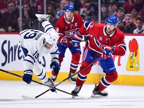 Chris Wideman #6 of the Montreal Canadiens takes down Calle Jarnkrok #19 of the Toronto Maple Leafs during the first period at Centre Bell on October 12, 2022 in Montreal.