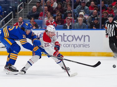 Cole Caufield #22 of the Montreal Canadiens takes a shot on a breakaway as Owen Power #25 of the Buffalo Sabres defends during the first period at KeyBank Center on Oct. 27, 2022 in Buffalo, N.Y.