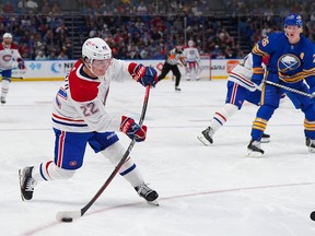 Montreal Canadiens winger Cole Caufield takes a shot as Rasmus Dahlin of the Buffalo Sabres looks on during the third period in Buffalo on Oct. 27, 2022