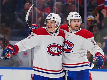 Kaiden Guhle #21 and Josh Anderson #17 of the Montreal Canadiens celebrate a goal by Anderson against the Buffalo Sabres during the third period at KeyBank Center on October 27, 2022 in Buffalo, N.Y.