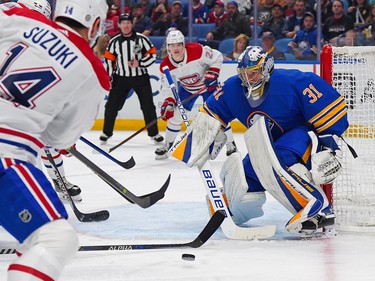 Eric Comrie #31 of the Buffalo Sabres makes the save against Nick Suzuki #14 of the Montreal Canadiens during the third period at KeyBank Center on Oct. 27, 2022 in Buffalo, N.Y.