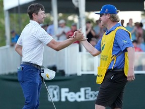 Mackenzie Hughes of Canada celebrates with his caddie Jace Walker on the second playoff hole against Sepp Straka of Austria on the 18th green during the final round of the Sanderson Farms Championship at The Country Club of Jackson on Sunday, Oct. 2, 2022, in Jackson, Miss.