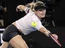 Canada's Eugenie Bouchard reaches for a backhand return to United States' Serena Williams during their second round match at the Australian Open tennis championships in Melbourne, Australia, Thursday, Jan. 17, 2019.
