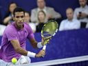 Montreal's Félix Auger-Aliassime returns the ball during the men's singles final against Sebastian Korda of the United States at the European Open tennis tournament in Antwerp, Belgium, on Sunday, Oct. 23, 2022.