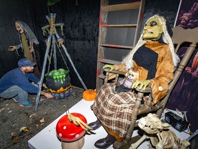 Danny Perreault works on one of the displays at his haunted house on Lake Ave. in Dorval on Tuesday Oct. 18, 2022.