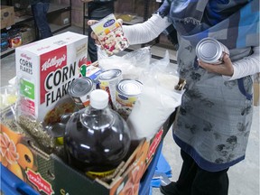 Food bank workers fill baskets in this file photo.