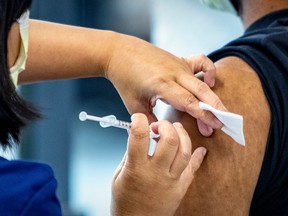 A man receives a vaccine dose in Montreal in this file photo.